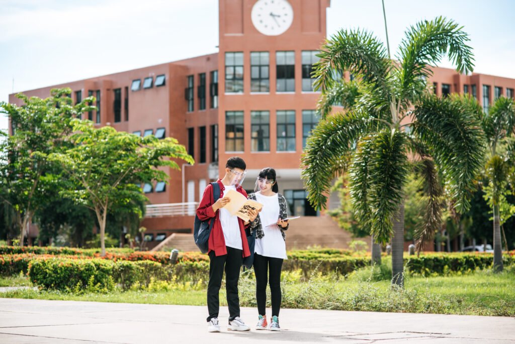 Male and female students wear a face Chill and stand in front of the university.