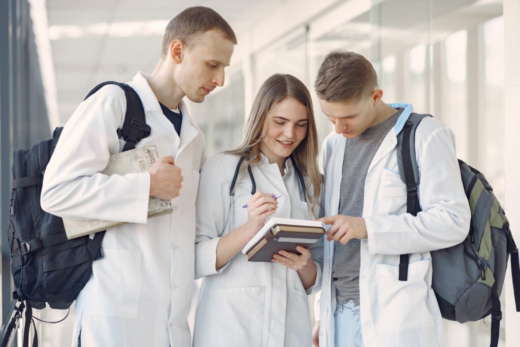Medical students at the hall. People in a white uniform.
